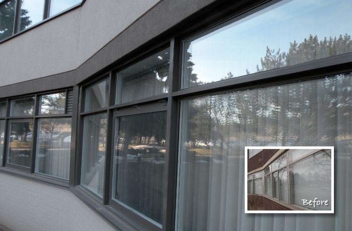 Row of new dark-framed ground floor windows beneath a refinished wall; inset shows the previous windows
